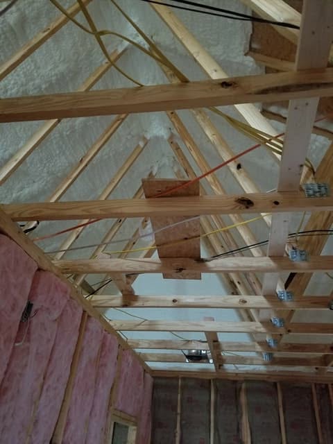 Spray foam insulation covering an attic roof deck in a Random County home