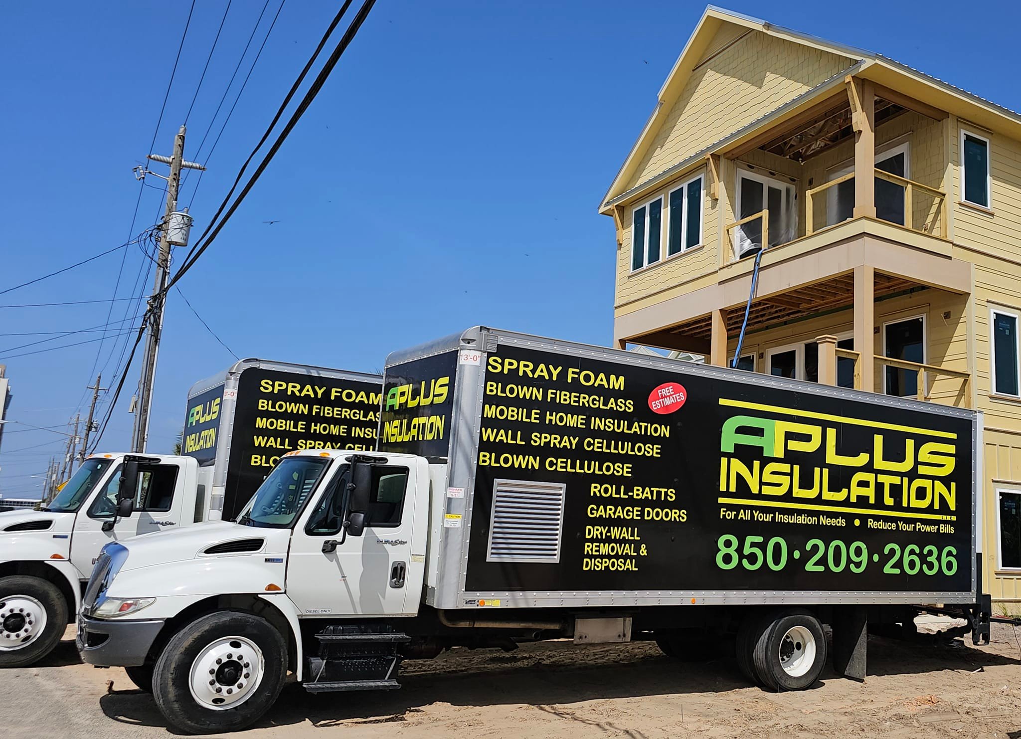A Plus Insulation service trucks parked at a Florida Panhandle job site